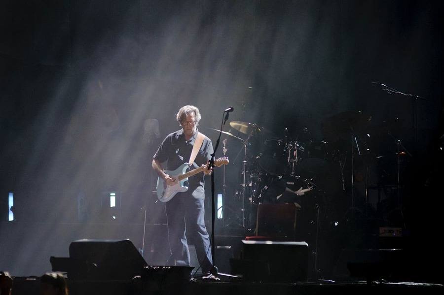 Eric Clapton performs on stage. 