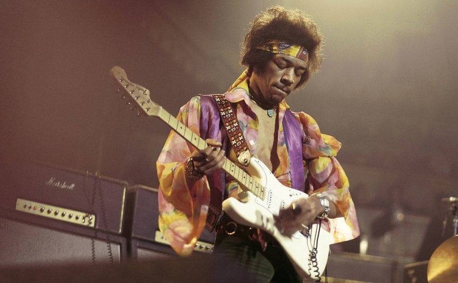 Jimi Hendrix performs on stage. 