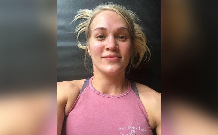 Carrie takes a selfie during a workout. 