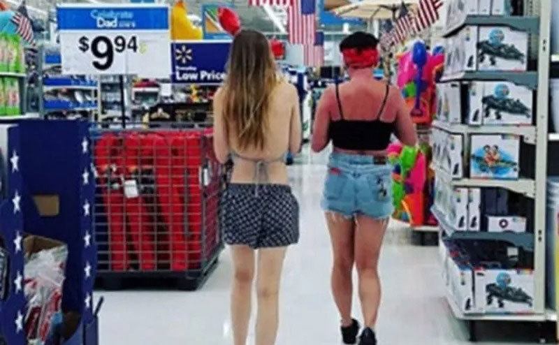 A woman walks through the store with a truly bad sunburn. 