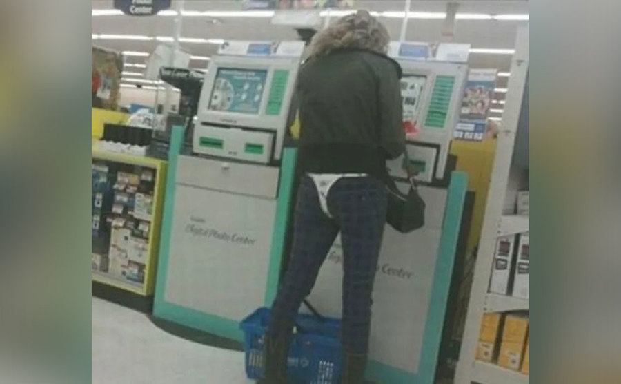 A woman wears her underwear over her pants. 